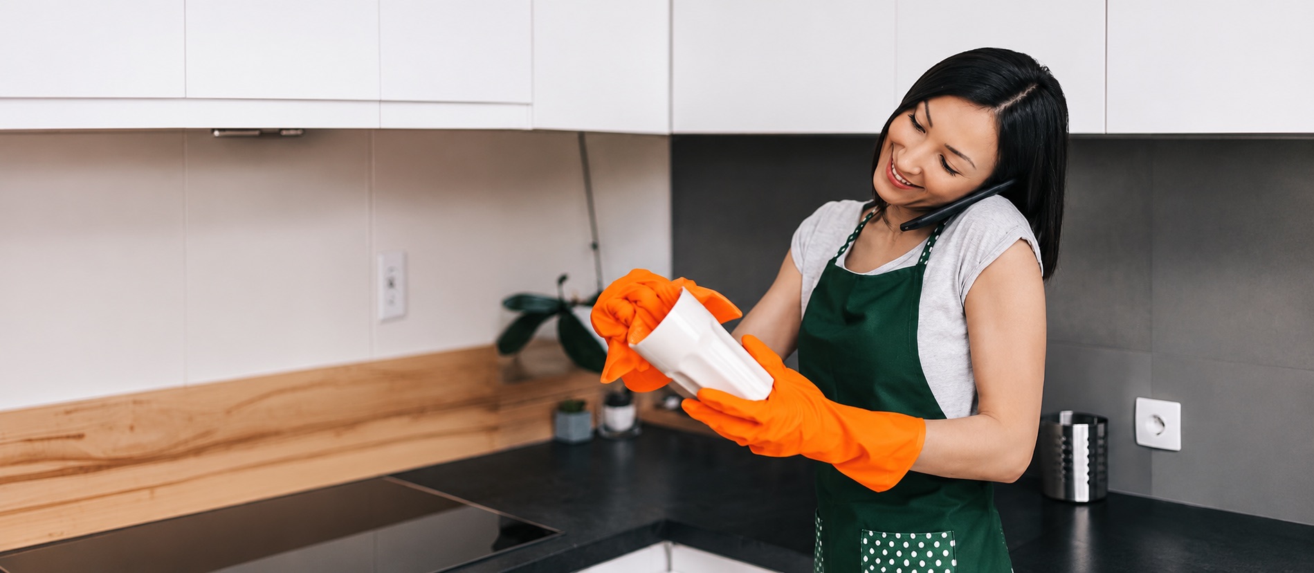 Shining Services team member taking a customer call in a bright Australian kitchen